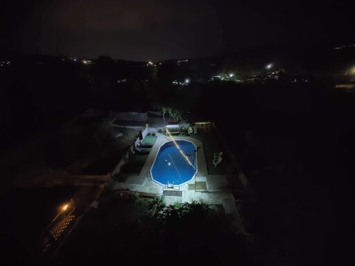 backyard with pool at night